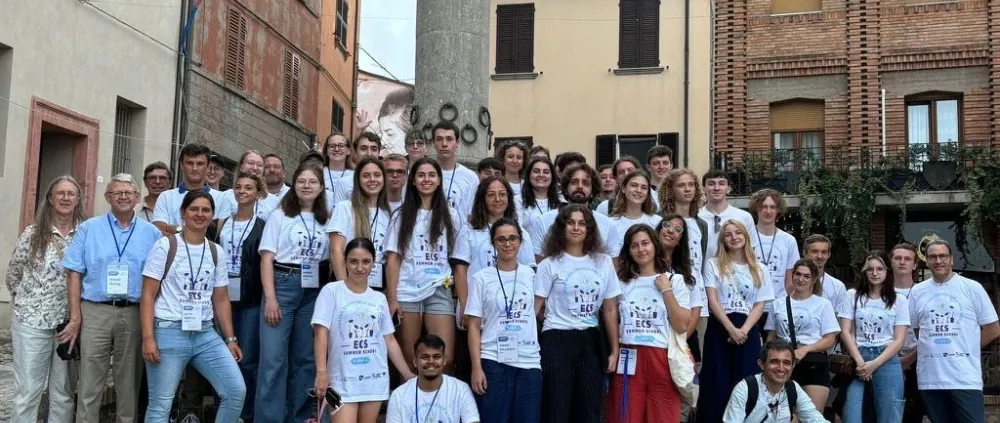 The participants of the ECSA Summer School in a group photo surrounded by the walls of a small Italian town.